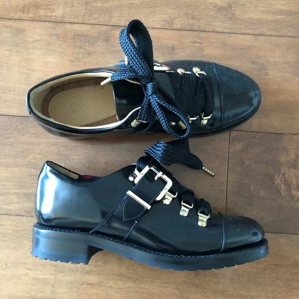 Black patent leather Angela Scott loafers.